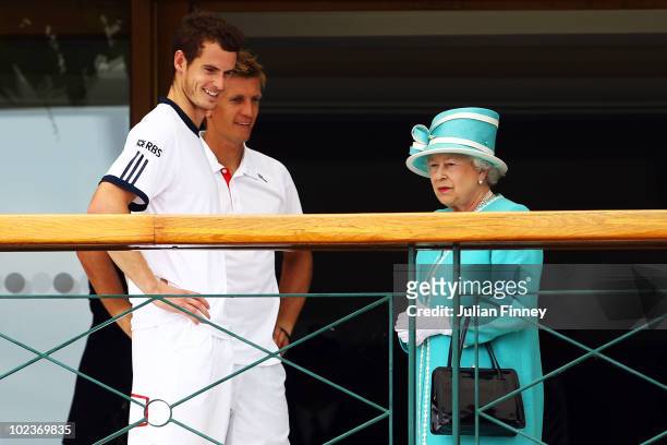 Andy Murray of Great Britain and Jarkko Nieminen of Finland meet Queen Elizabeth II after their match on Day Four of the Wimbledon Lawn Tennis...