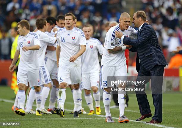 Vladimir Weiss head coach of Slovakia instructs Martin Skrtel as Robert Vittek of Slovakia celebrates scoring the opening goal during the 2010 FIFA...