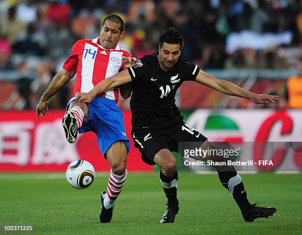 Paulo Da Silva of Paraguay tussles with Rory Fallon of New Zealand during the 2010 FIFA World Cup South Africa Group F match between Paraguay and New...