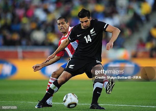 Paulo Da Silva of Paraguay tussles with Rory Fallon of New Zealand during the 2010 FIFA World Cup South Africa Group F match between Paraguay and New...