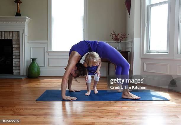 mother and child practicing yoga and playing - elastic stock pictures, royalty-free photos & images