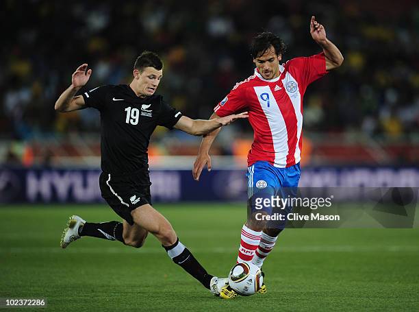 Tommy Smith of New Zealand and Roque Santa Cruz of Paraguay battle for the ball during the 2010 FIFA World Cup South Africa Group F match between...