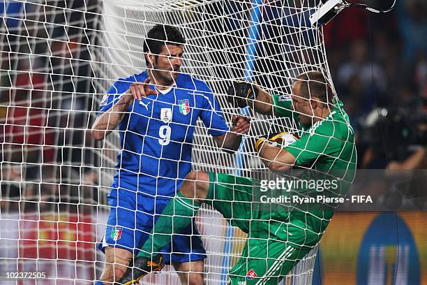 Vincenzo Iaquinta of Italy tussles with goalkeeper Jan Mucha of Slovakia during the 2010 FIFA World Cup South Africa Group F match between Slovakia...