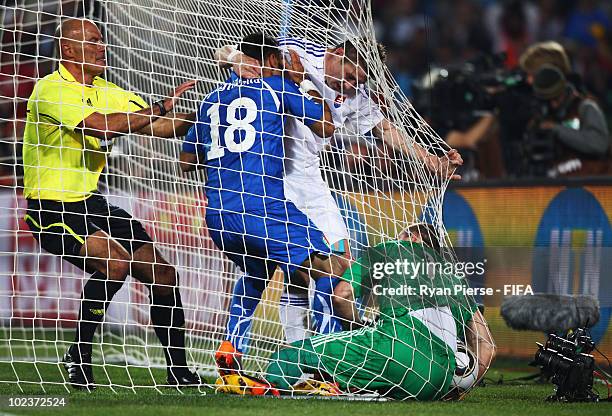 Referee Howard Webb of England intervenes as Fabio Quagliarella of Italy tussles with Juraj Kucka of Slovakia and goalkeeper Jan Mucha of Slovakia...