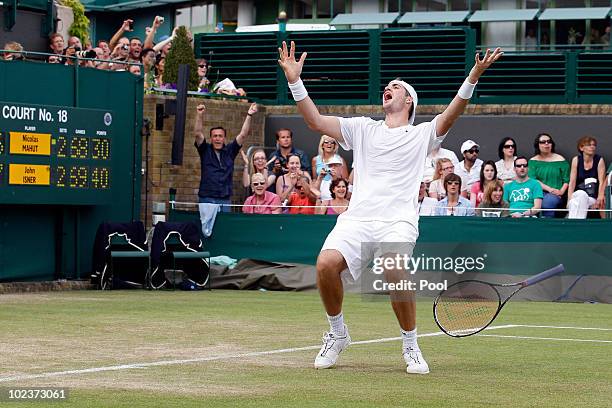 John Isner of USA celebrates winning on the third day of his first round match against Nicolas Mahut of France on Day Four of the Wimbledon Lawn...