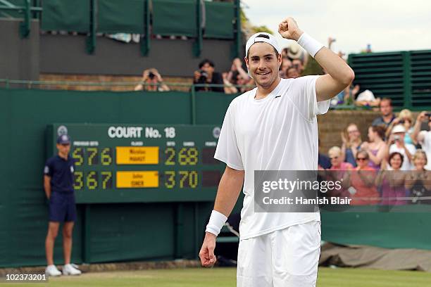 John Isner of USA celebrates winning on the third day of his first round match against Nicolas Mahut of France on Day Four of the Wimbledon Lawn...