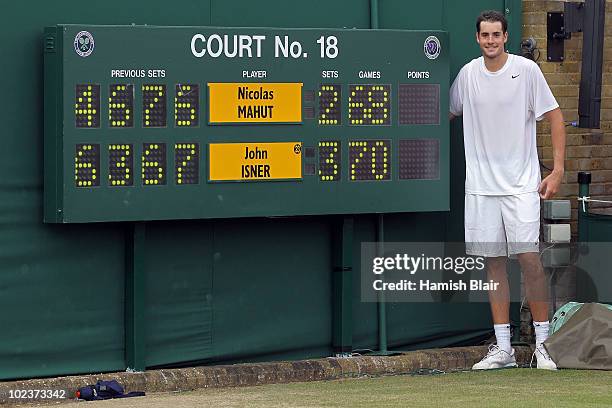 John Isner of USA poses after winning on the third day of his first round match against Nicolas Mahut of France with on Day Four of the Wimbledon...