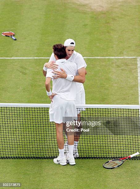 John Isner of USA celebrates winning on the third day of his first round match against Nicolas Mahut of France on Day Four of the Wimbledon Lawn...