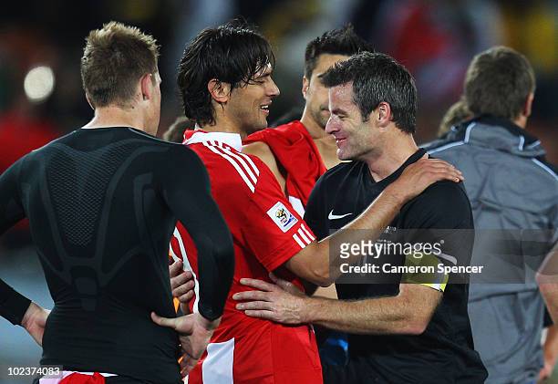 Roque Santa Cruz of Paraguay consoles a dejected Ryan Nelsen of New Zealand after a goalless draw and elimination in the 2010 FIFA World Cup South...