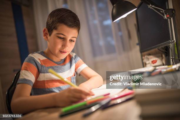 boy doing homework - desk lamp stock pictures, royalty-free photos & images