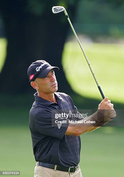 Corey Pavin, current United States Ryder Cup captain, watches his shot during the first round of the Travelers Championship held at TPC River...