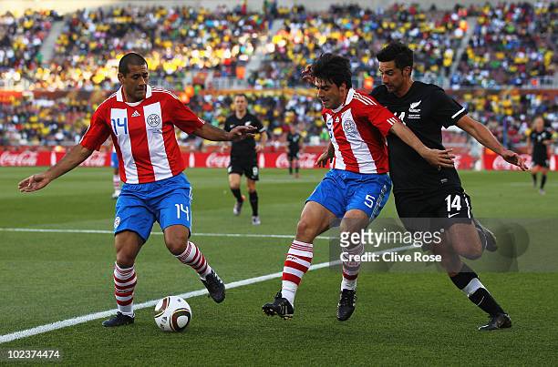 Paulo Da Silva and Julio Cesar Caceres of Paraguay shield the ball from Rory Fallon of New Zealand during the 2010 FIFA World Cup South Africa Group...