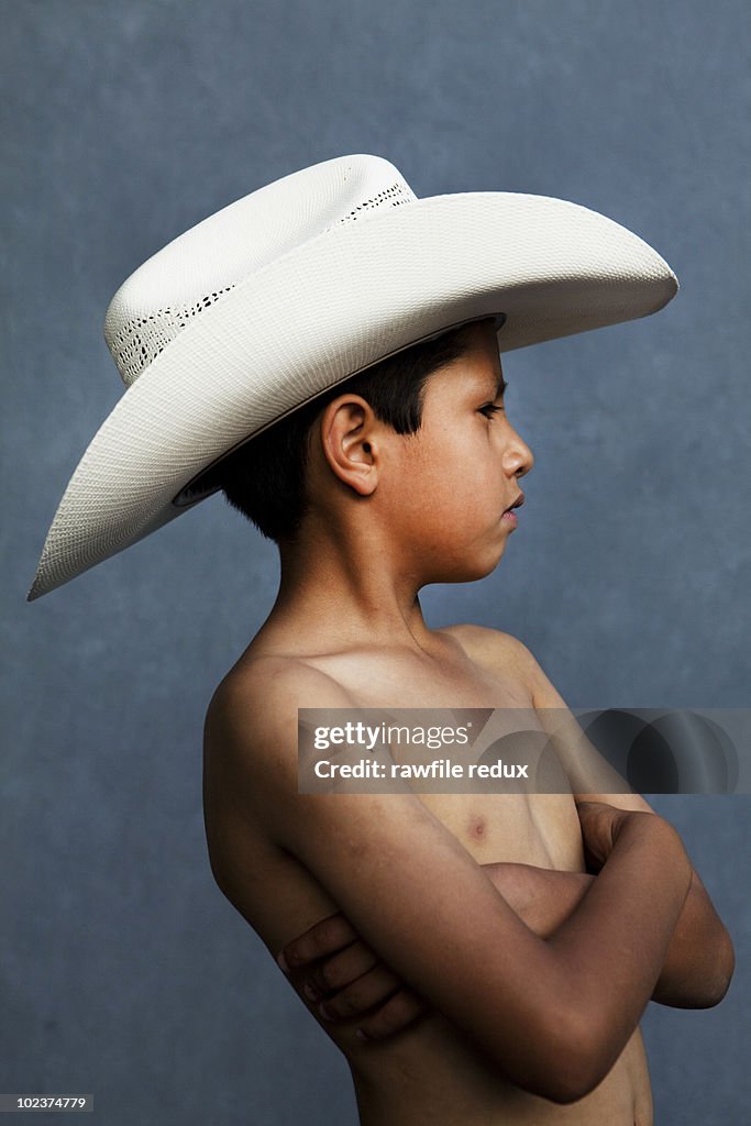 Young boy wearing a cowboy hat