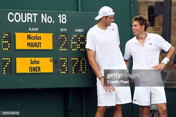 John Isner of USA poses after winning on the third day of his first round match against Nicolas Mahut of France on Day Four of the Wimbledon Lawn...