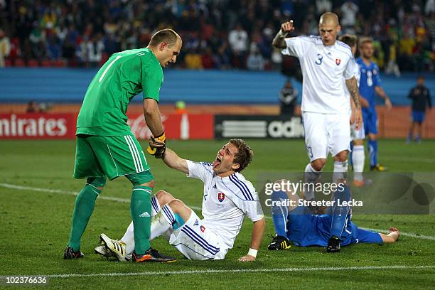Peter Pekarik of Slovakia is helped up by team mate Jan Mucha during the 2010 FIFA World Cup South Africa Group F match between Slovakia and Italy at...