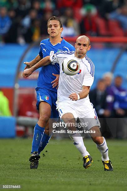 Domenico Criscito of Italy and Robert Vittek of Slovakia battle for the ball during the 2010 FIFA World Cup South Africa Group F match between...
