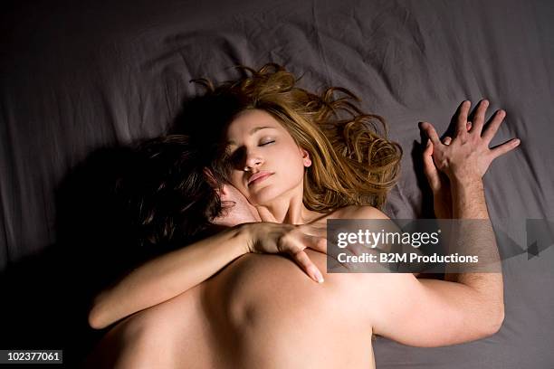 couple engaged in sexual intercourse on bed - couple lust stock-fotos und bilder