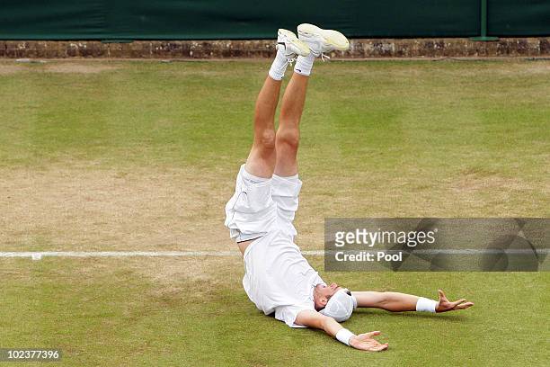 John Isner of USA celebrates winning on the third day of his first round match against Nicolas Mahut of France on Day Four of the Wimbledon Lawn...