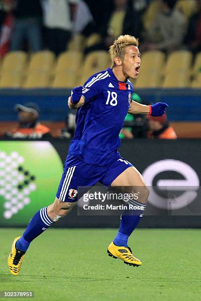 Keisuke Honda of Japan celebrates scoring the opening goal from a free kick during the 2010 FIFA World Cup South Africa Group E match between Denmark...