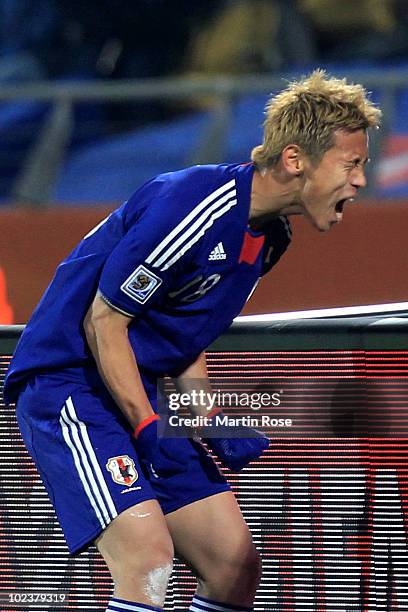 Keisuke Honda of Japan celebrates scoring the opening goal from a free kick during the 2010 FIFA World Cup South Africa Group E match between Denmark...