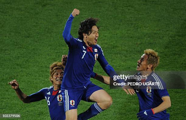 Japan's midfielder Yasuhito Endo celebrates with Japan's striker Yasuhito Okubo and Japan's midfielder Daisuke Matsui after scoring during the Group...