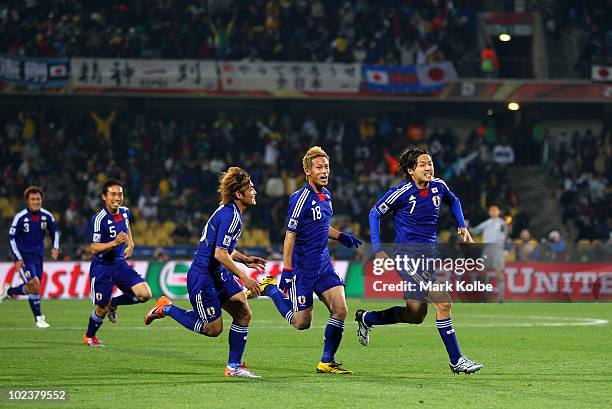 Yasuhito Endo of Japan celebrates scoring his team's second goal from a free kick during the 2010 FIFA World Cup South Africa Group E match between...