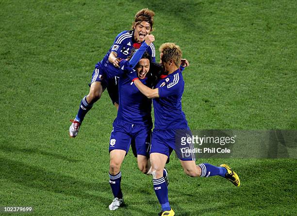 Yasuhito Endo of Japan celebrates scoring his team's second goal from a free kick, with Yoshito Okubo and Keisuke Honda of Japan during the 2010 FIFA...