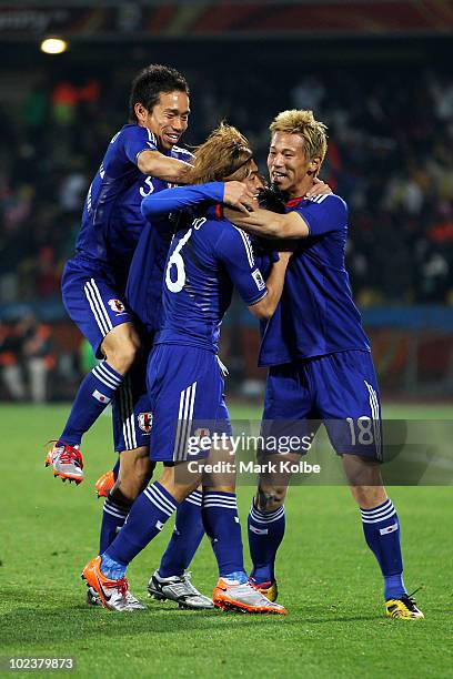 Yasuhito Endo of Japan celebrates scoring his team's second goal from a free kick with team mates during the 2010 FIFA World Cup South Africa Group E...