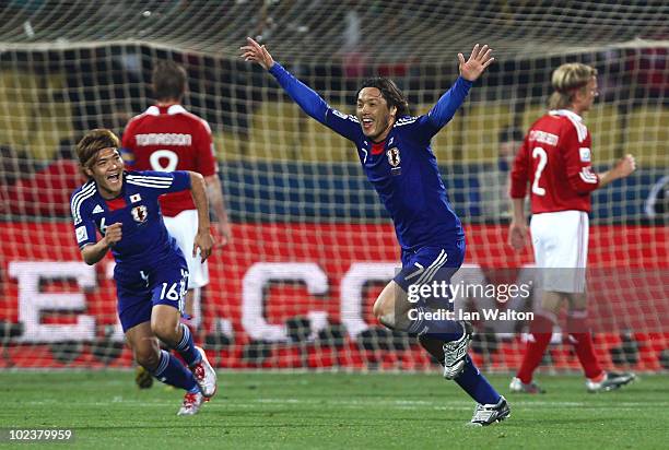 Yasuhito Endo of Japan celebrates scoring his team's second goal from a free kick, with Yoshito Okubo during the 2010 FIFA World Cup South Africa...