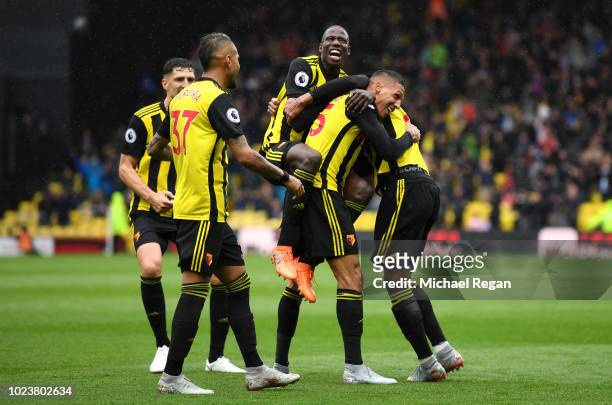 Jose Holebas of Watford celebrates with teammates after scoring his team's second goal during the Premier League match between Watford FC and Crystal...