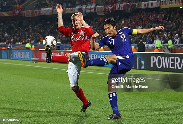 Thomas Kahlenberg of Denmark defends a cross from Makoto Hasebe of Japan during the 2010 FIFA World Cup South Africa Group E match between Denmark...