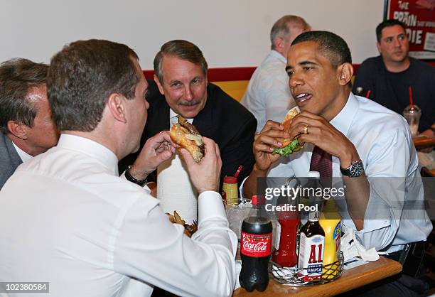 President Barack Obama and Russian Federation President Dmitry Medvedev eat cheeseburgers at Ray's Hell Burger June 24, 2010 in Arlington, Virgina....