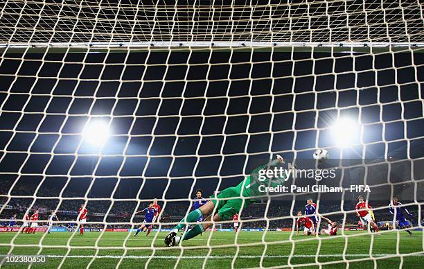 Goalkeeper Thomas Sorensen of Denmark fails to stop a direct free kick from Keisuke Honda of Japan during the 2010 FIFA World Cup South Africa Group...