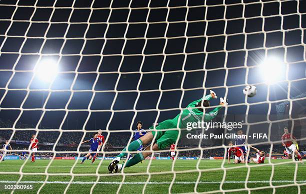 Goalkeeper Thomas Sorensen of Denmark fails to stop a direct free kick from Keisuke Honda of Japan during the 2010 FIFA World Cup South Africa Group...