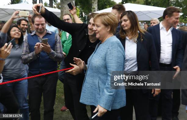 German Chancellor Angela Merkel greets visitors at the annual open-house day at the Chancellery on August 26, 2018 in Berlin, Germany. Hundreds of...