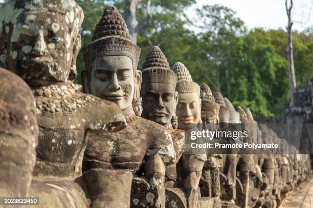 giants in front gate of angkor thom, in angkor wat, siem reap in cambodia. - siem reap stockfoto's en -beelden