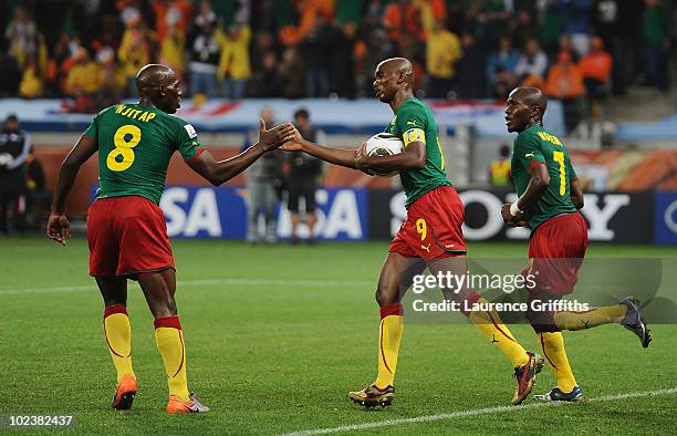 Samuel Eto'o of Cameroon celebrates scoring from a penalty kick with team mates Geremi and Landry N'Guemo of Cameroon during the 2010 FIFA World Cup...