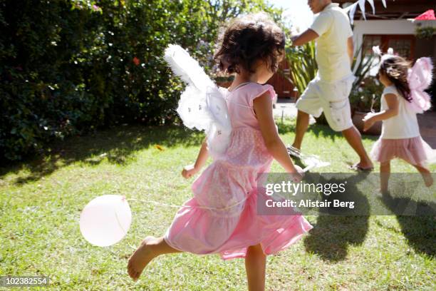 girls dressed as fairies, running in garden - daughter birthday stock pictures, royalty-free photos & images