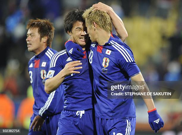 Japan's striker Shinji Okazaki celebrates with Japan's midfielder Keisuke Honda after scoring during the Group E first round 2010 World Cup football...