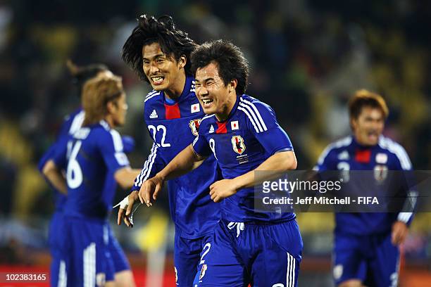 Shinji Okazaki of Japan celebrates scoring with teammate Yuji Nakazawa during the 2010 FIFA World Cup South Africa Group E match between Denmark and...