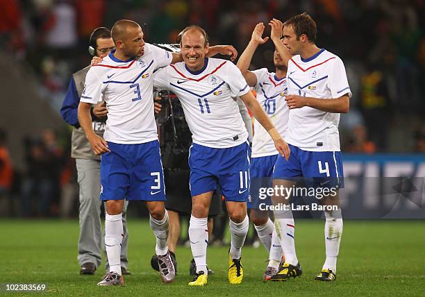 Arjen Robben of the Netherlands celebrates with team mate John Heitinga after Klaas Jan Huntelaar scores his side's second goal during the 2010 FIFA...