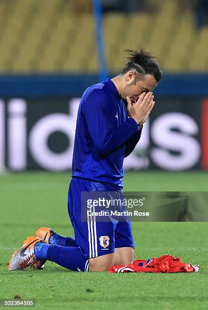 Marcus Tulio Tanaka of Japan celebrates victory by praying, after knocking Denmark out of the competition during the 2010 FIFA World Cup South Africa...