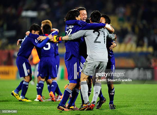 Eiji Kawashima of Japan celebrates victory with team mates following the 2010 FIFA World Cup South Africa Group E match between Denmark and Japan at...