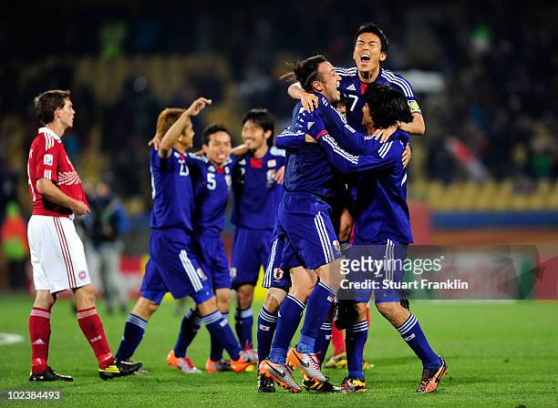 Japan players celebrate victory following the 2010 FIFA World Cup South Africa Group E match between Denmark and Japan at the Royal Bafokeng Stadium...