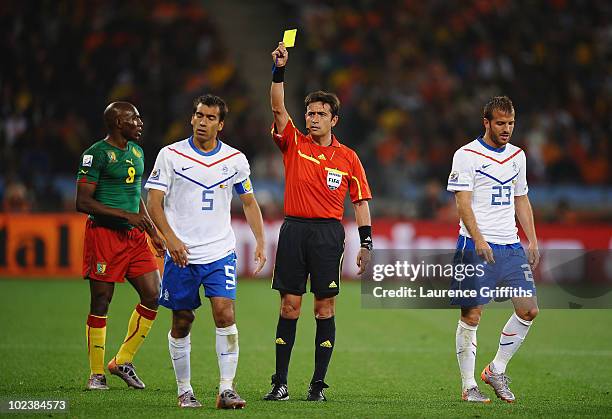 Giovanni Van Bronckhorst of the Netherlands receives a yellow card from referee Pablo Pozo during the 2010 FIFA World Cup South Africa Group E match...