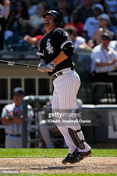 Paul Konerko of the Chicago White Sox follows the flight of his game winning home run, a two-run shot in the 8th inning, against the Atlanta Braves...