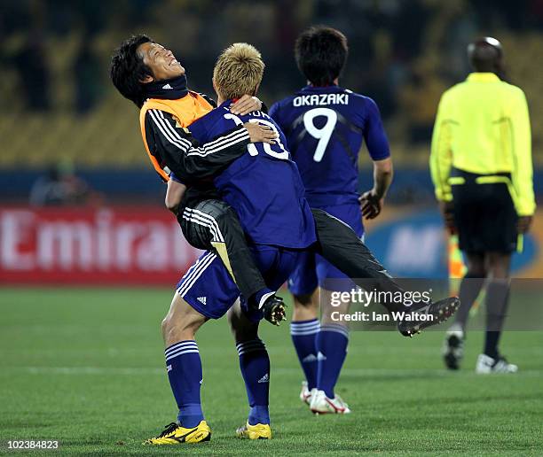 Keisuke Honda of Japan celebrates victory with a team mate during the 2010 FIFA World Cup South Africa Group E match between Denmark and Japan at the...