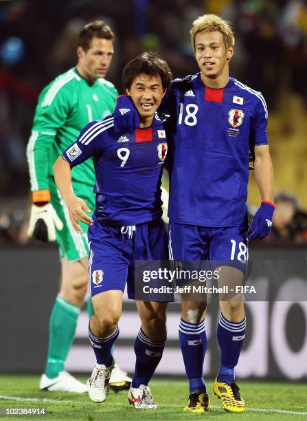 Shinji Okazaki of Japan celebrates scoring with teammate Keisuke Honda during the 2010 FIFA World Cup South Africa Group E match between Denmark and...