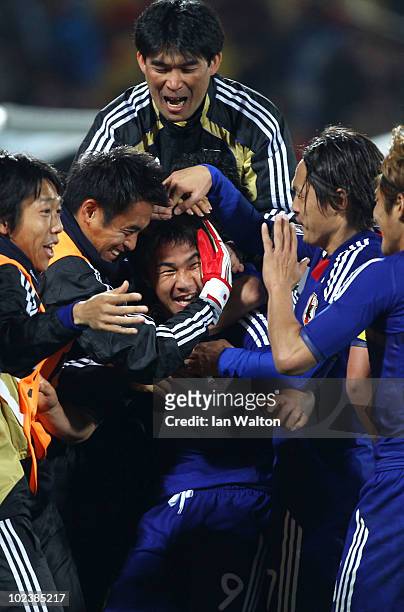 Shinji Okazaki of Japan celebrates scoring his team's third goal with team mates during the 2010 FIFA World Cup South Africa Group E match between...
