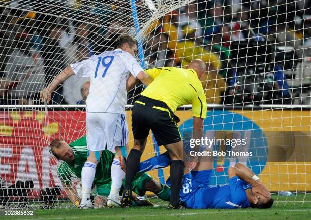 Referee Howard Webb looks down at Fabio Quagliarella of Italy as the player puts his hands over his face after trying to get the ball from goalkeeper...
